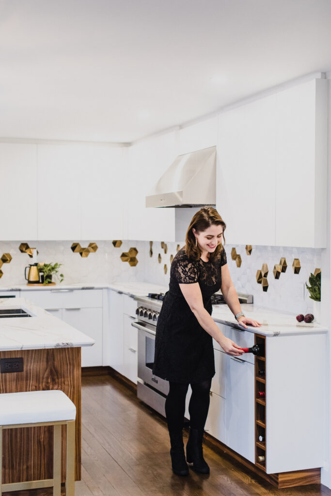Helen, a professional home stager and designer, stands in a bright and inviting kitchen with a warm smile on her face, ready to help you transform your space.