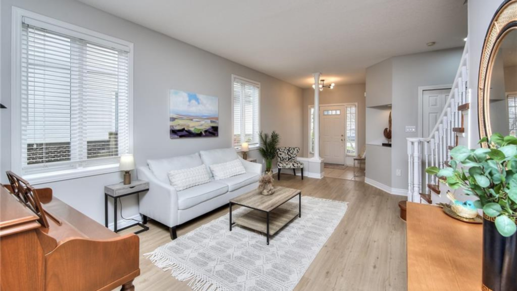 This photo showcases a stunningly staged living room, complete with couch, table, and cozy carpet, courtesy of Helen's Team.