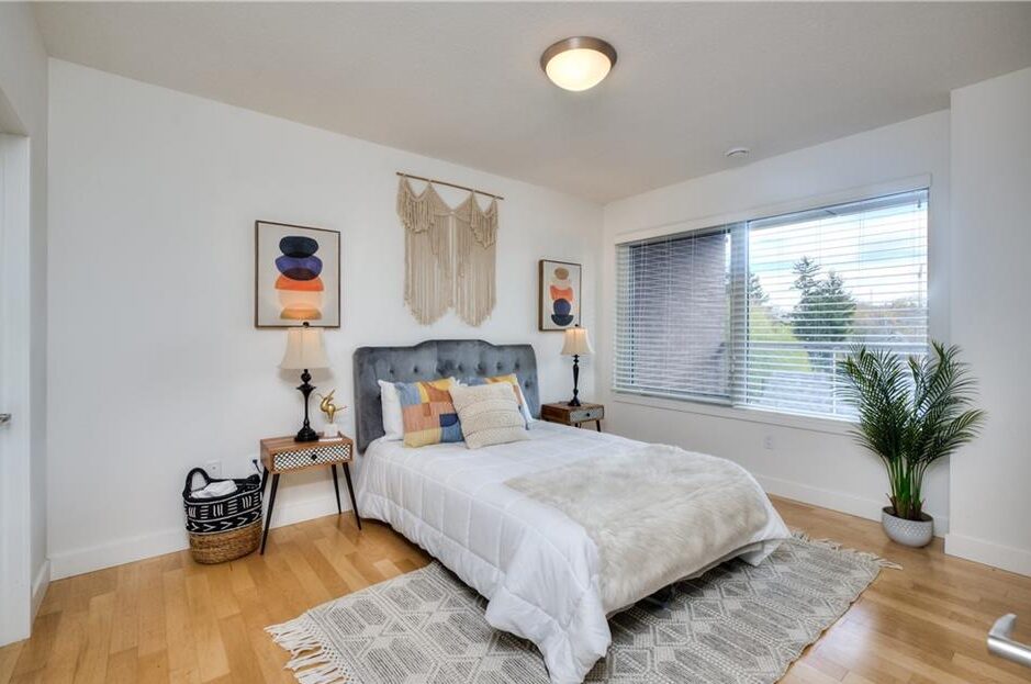 Expertly staged bedroom with elegant blinds, a comfortable bed, carpet, and thoughtfully curated accessories, all orchestrated by Helen for a stylish and inviting atmosphere.